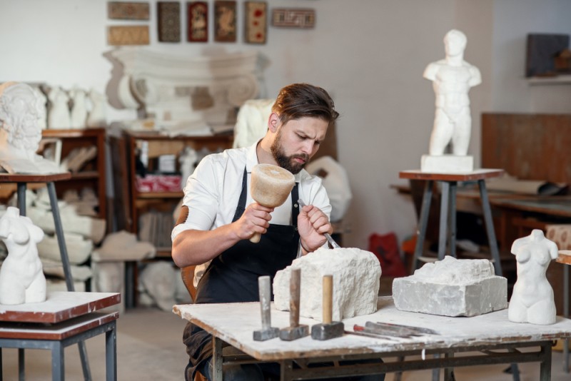mestesugar care sculpteaza piatra in atelier